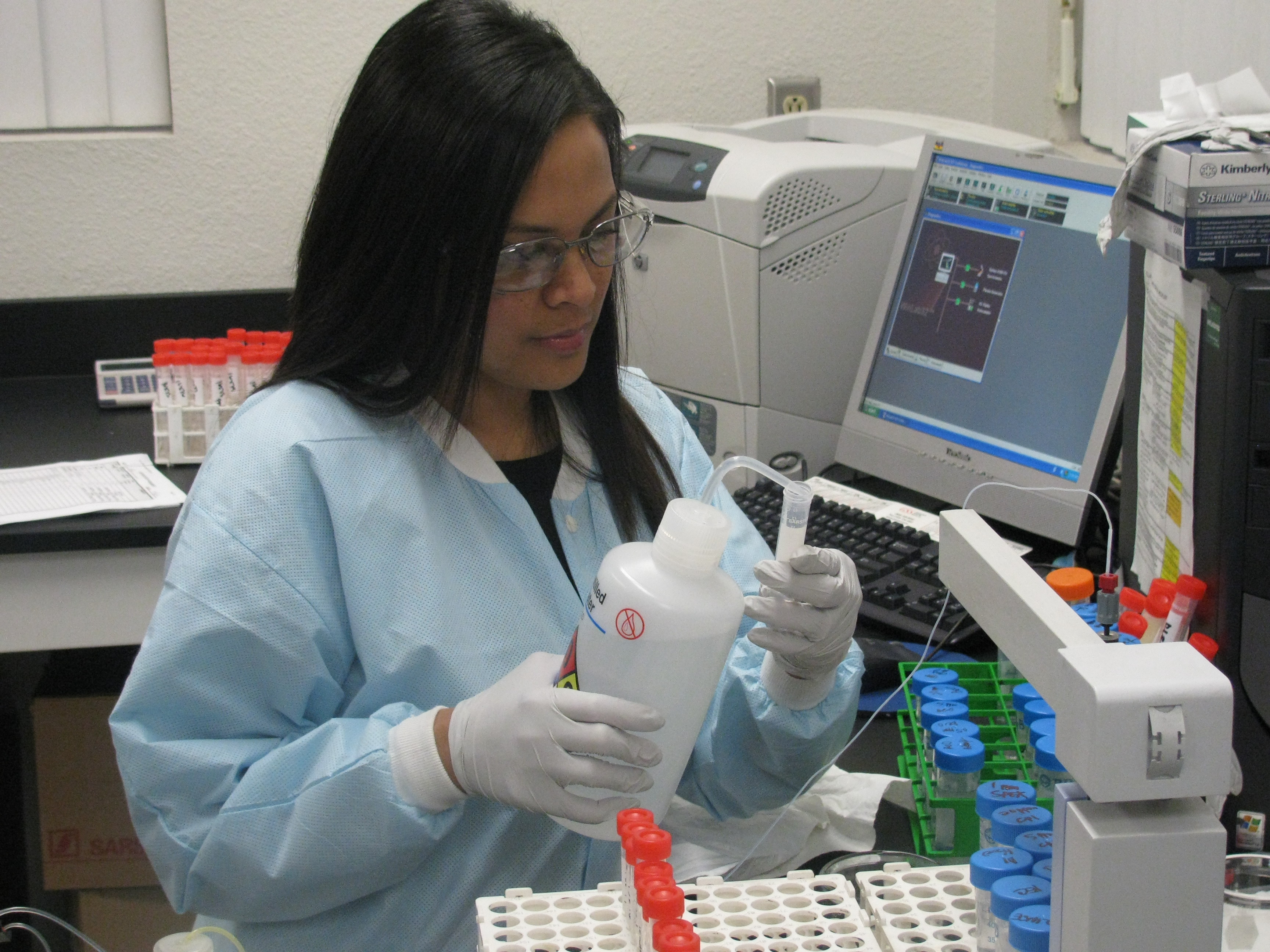 Ms. Mary Joy Dumaran, Chemist, prepares samples for analysis of metals